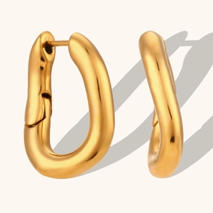 Detailed view of chunky 18K gold plated U-shaped earrings with mirror finish