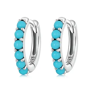 Sterling silver hoop earrings with turquoise beads and S925 engraving on white background