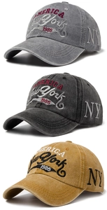 Detail of vintage washed cotton baseball caps with embroidered New York 1985 text