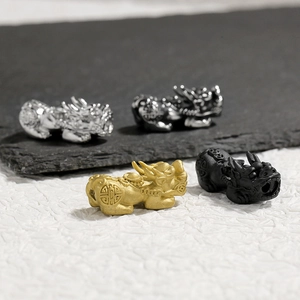 Detailed close-up of 304 stainless steel Pi Xiu charms in four metallic color finishes