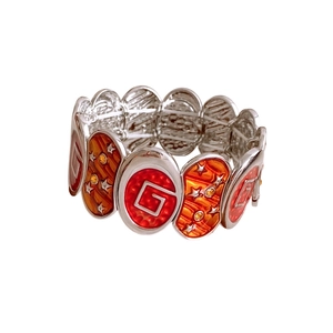 Vintage elastic bracelet featuring orange and red enamel oval pieces with G letter