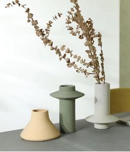 Detail of Morandi-colored ceramic vases showing fine brushed matte texture and modern shapes