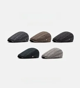 Selection of British style flat caps for men in various colors with textured fabric