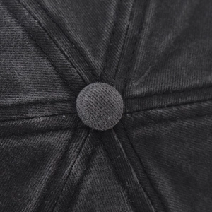 Macro shot of 6-panel washed cotton baseball cap crown with stitched top button detail