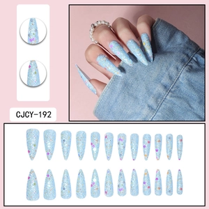 Long stiletto press-on nails in light blue with colorful glitter and sequins detail