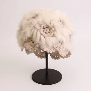 Handmade crochet winter hat with plush faux fur and elegant hollow flower pattern in beige