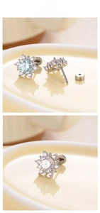 Detailed macro view of snowflake stud earrings with blue zircon and secure screw backs