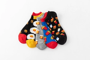 Flat lay of five pairs of cotton low cut socks featuring creative colorful food patterns