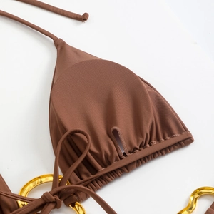 Detail of brown bikini top with triangle cups, ribbed fabric and gold metal rings