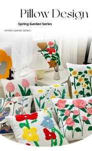 Detail of floral tulip embroidery on thick cotton linen pillow with tufted textures