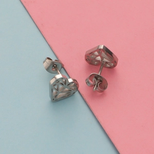 Geometric heart-shaped stainless steel stud earrings in silver finish on colorful background