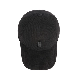Winter men's warm baseball cap with ear flaps in black textured fabric and sports label