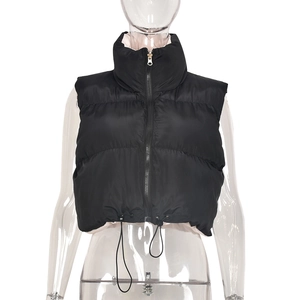Detail of black stand-collar puffer vest with front zipper and adjustable drawstring hem