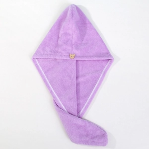 Detail of light purple coral fleece hair towel with a brown bear button fastener
