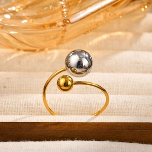 Macro shot of gold wrap ring featuring mixed gold and silver beads on linen display
