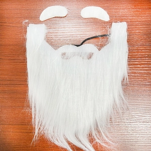 Detailed view of fluffy white Santa Claus beard and eyebrows set on wooden surface