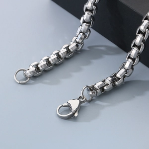 Detail of square Byzantine chain link and lobster clasp in polished stainless steel