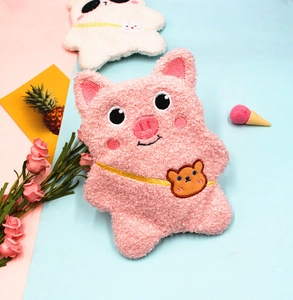 Close-up of soft sherpa plush pencil case featuring cute pink pig and white panda embroidery