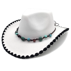 White felt fedora hat with turquoise beaded band and woven trim shown from side angle
