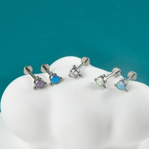 Detail of five G23 titanium opal labret studs with curved triangular zircon flower tops