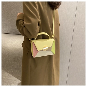 Detailed view of a multi-color geometric PU leather crossbody bag worn by a model