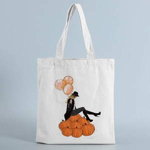 Close-up of canvas tote bag with fashionable Halloween pumpkin and balloons print