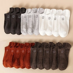 Detailed close-up of multi-colored cotton ankle socks featuring cute smiley face embroidery