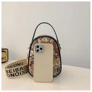 Detailed view of mini printed handbag with bear patterns and lettered shoulder strap