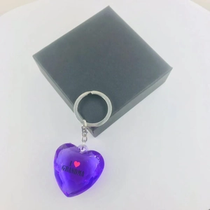Macro detail of purple acrylic heart keychain with I Love Grandma text and gift box