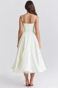 Detail view of white satin dress back showing thin straps and hidden zipper closure