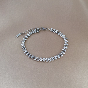 Detailed shot of silver wheat link stainless steel chain with lobster clasp and tag