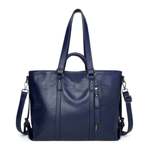Detail view of blue PU leather tote bag showing fine texture and vertical zipper pocket