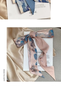 Detail of silk scarf with landscape ink print and Be Yourself text on satin fabric