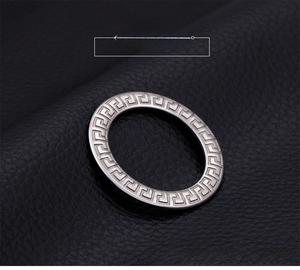 Macro shot of silver titanium steel ring with intricate Greek key pattern carving
