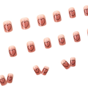Pink gradient short round press-on nails featuring minimalist black heart line patterns