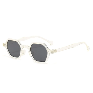 Modern hexagonal sunglasses with transparent frames and dark grey lenses in a side view