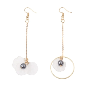 Detail of asymmetric gold earrings with white petals, grey pearls and gold circle