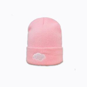 Close-up of a pink knitted beanie featuring detailed white cloud embroidery on the cuff