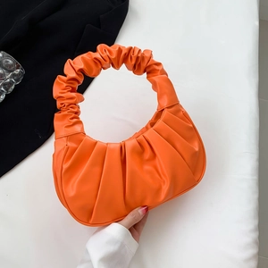 Minimalist bright orange pleated handbag with round handle and stylish cloud shape