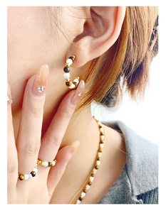 Close-up of S925 silver C-shape tiger eye earrings with matching necklace and ring set