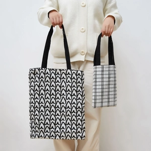 Detail view of double-sided canvas tote bags in heart print and checkered pattern
