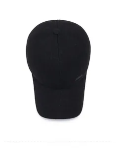 Top-down view of black winter baseball cap with felt texture and sport emblem