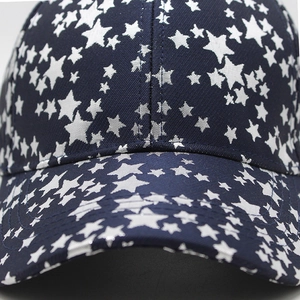 Detail of star pattern printing and reinforced stitching on navy blue baseball cap