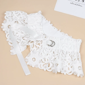 Macro view of white lace waist belt featuring delicate fabric texture and metal D-ring buckle