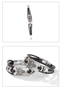 Details von geflochtenen Lederarmbändern mit graviertem Wolfskopf-Muster für Herren
