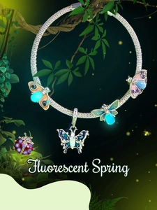 Glow-in-the-dark butterfly and ladybug silver charm with blue fluorescent effect
