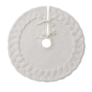 White knitted Christmas tree skirt with cable knit braid patterns for holiday home decor