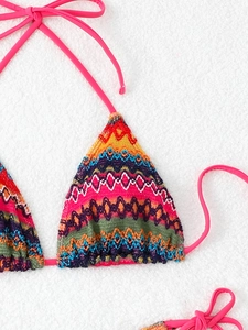 Detail of bohemian crochet bikini top featuring colorful geometric knit patterns and pink ties
