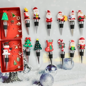 Christmas wine stoppers and glass markers with Santa and snowman on snowy background