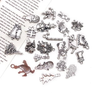 Flat lay of antique silver alloy Christmas charms for DIY jewelry and festive crafts